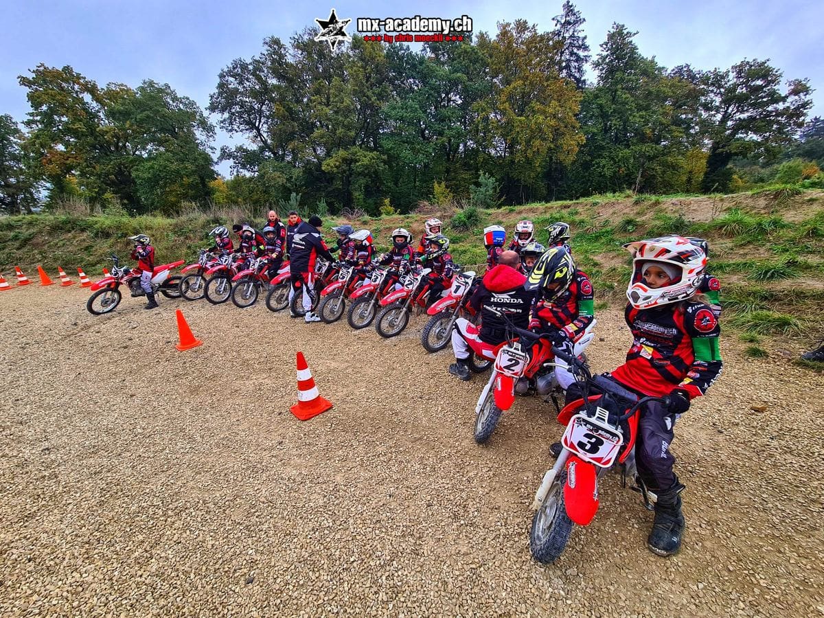 Children on small Honda CRF motocross bikes lined up for a kids motocross lesson at MX-Academy