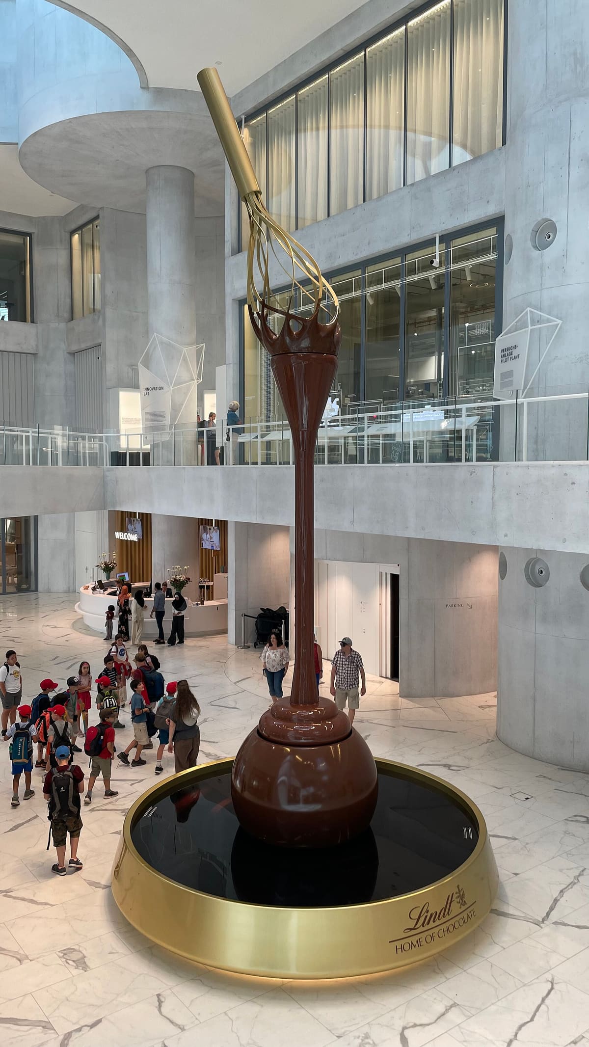 The tall chocolate fountain in the atrium of the Lindt Home of Chocolate in Kilchberg