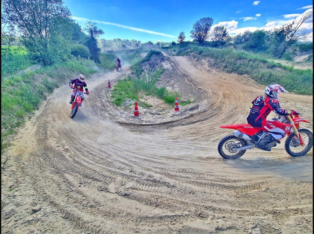 Riders on Honda motocross bikes practising cornering between cones at MX-Academy