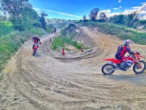 Riders on Honda motocross bikes practising cornering between cones at MX-Academy